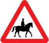 Accompanied horses or ponies likely to be in or crossing road ahead
